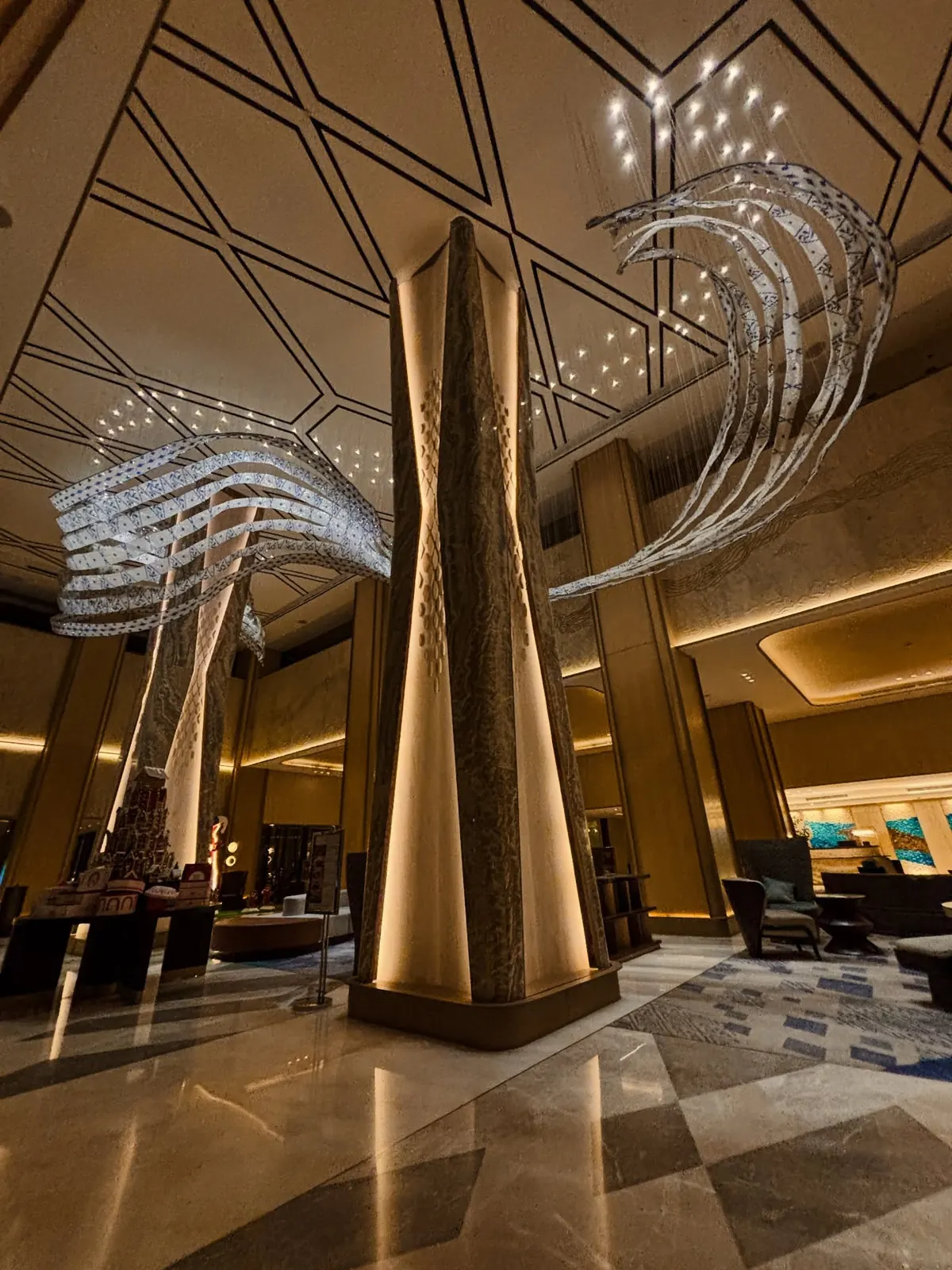 Sari Pacific · column detail. Onyx cladding, lit and lined through.