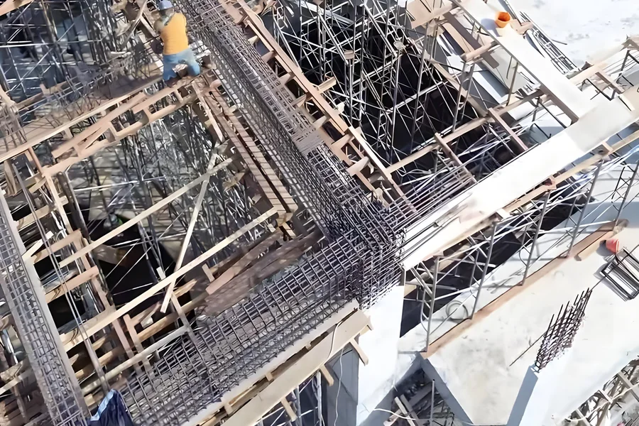 Rebar and formwork at structure stage. Cover checked before every pour.